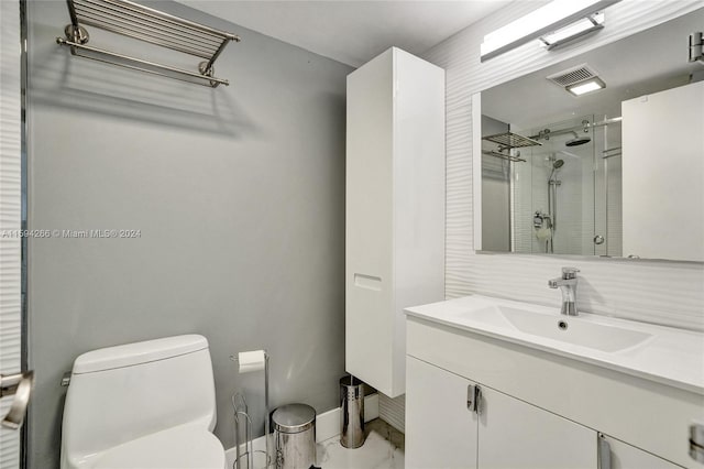 bathroom with vanity, toilet, and a shower with shower door