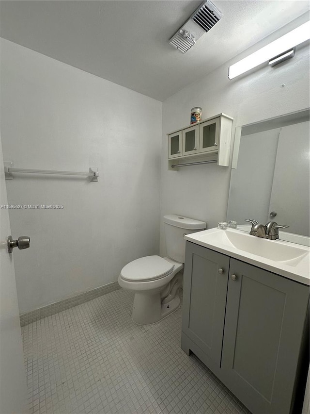 bathroom with tile patterned floors, vanity, and toilet