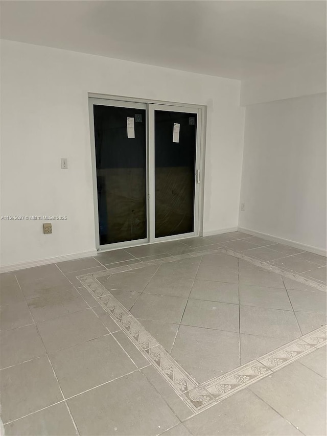 spare room with tile patterned flooring