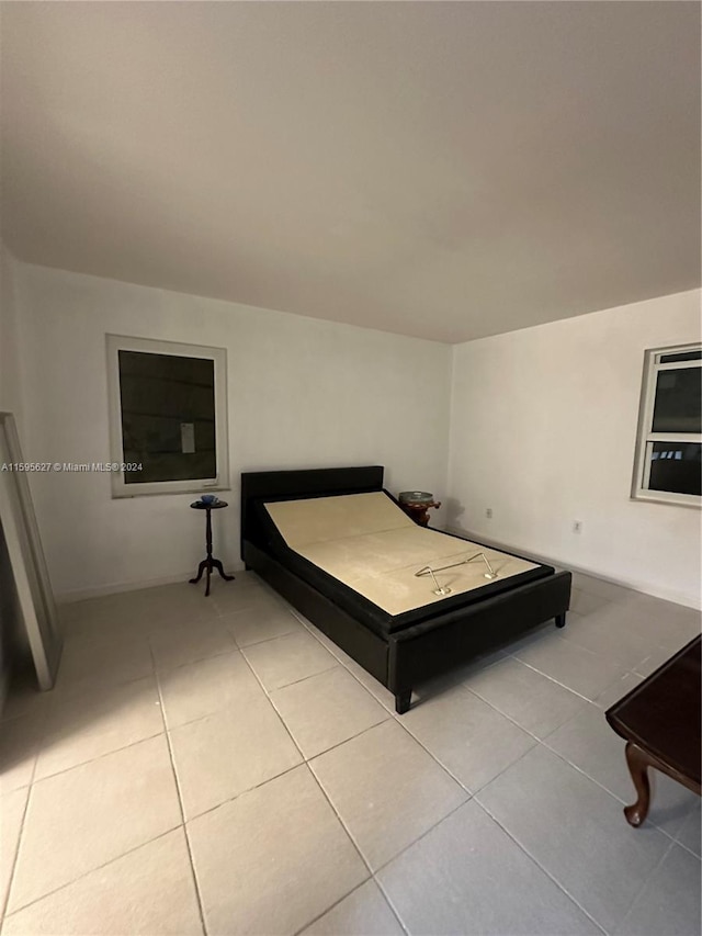 bedroom with light tile patterned flooring