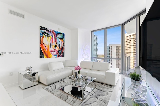 tiled living room featuring floor to ceiling windows