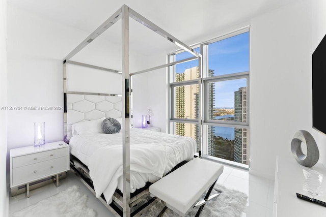 tiled bedroom with floor to ceiling windows