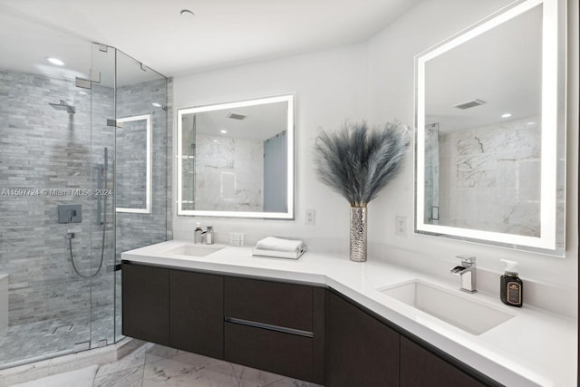 bathroom with a shower with shower door, double sink vanity, and tile floors