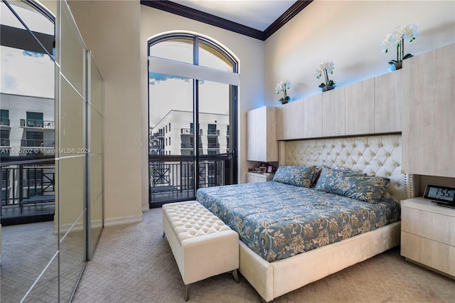 carpeted bedroom with a high ceiling and crown molding