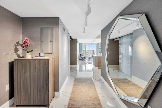 hallway with light tile floors and rail lighting