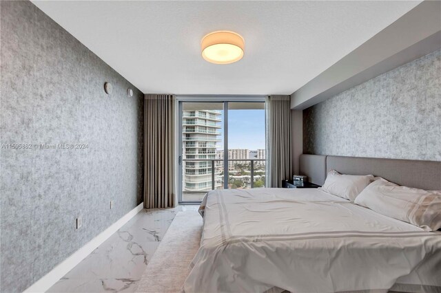 bedroom featuring access to outside and floor to ceiling windows