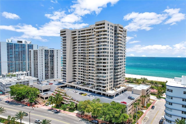 view of property featuring a water view and a beach view