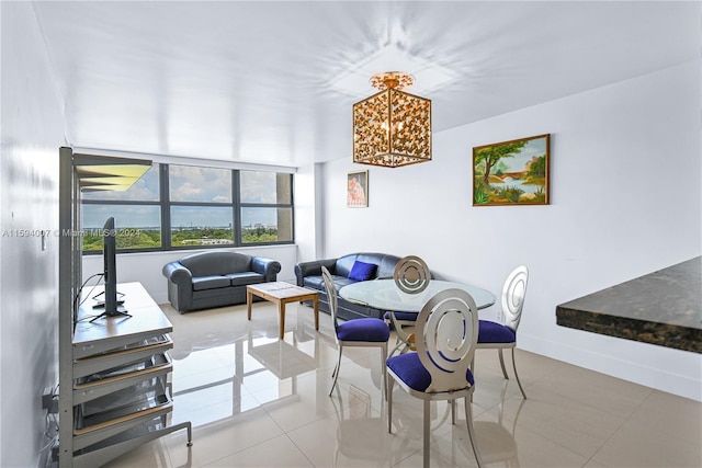 living room with tile patterned floors and a notable chandelier