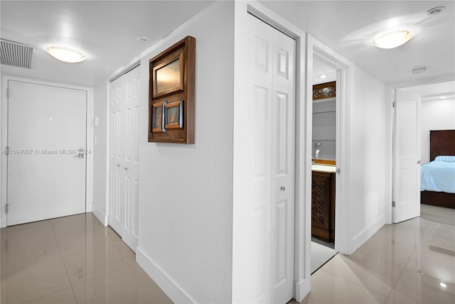 hallway with light tile patterned flooring