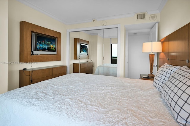 bedroom with a closet and ornamental molding