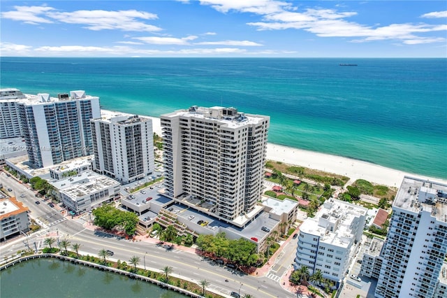 aerial view with a water view and a view of the beach