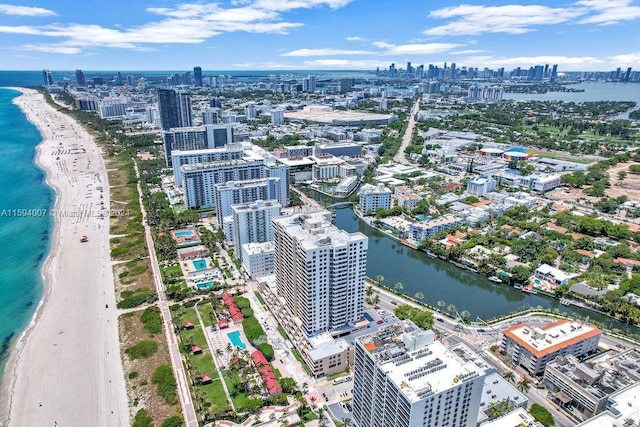 drone / aerial view featuring a water view and a view of the beach