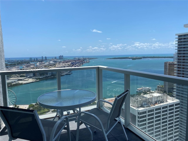 balcony with a water view and a city view