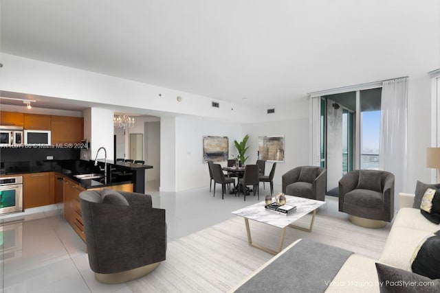 living area featuring visible vents and a notable chandelier