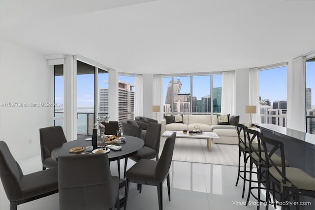 dining room with floor to ceiling windows and a city view