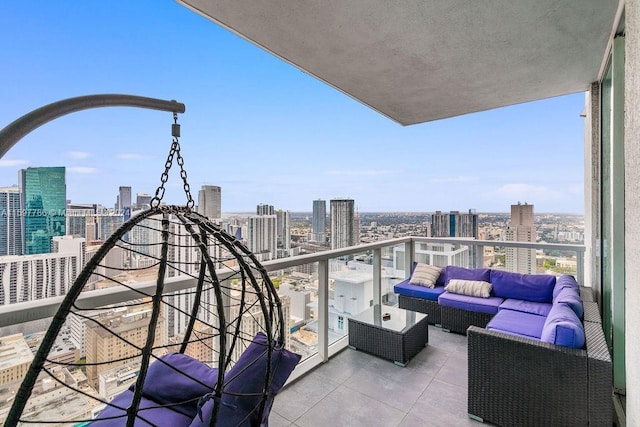 balcony with a view of city and an outdoor hangout area