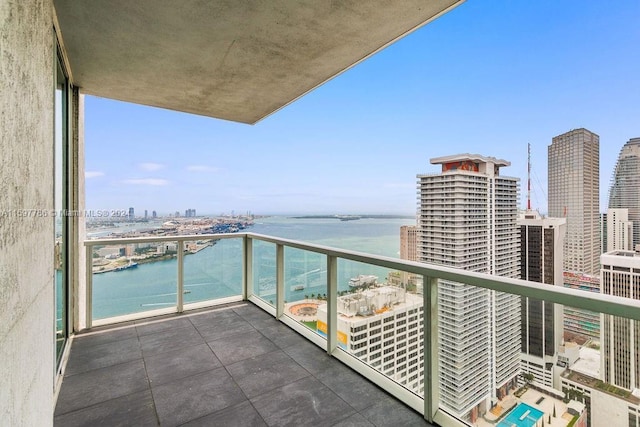 balcony with a view of city and a water view