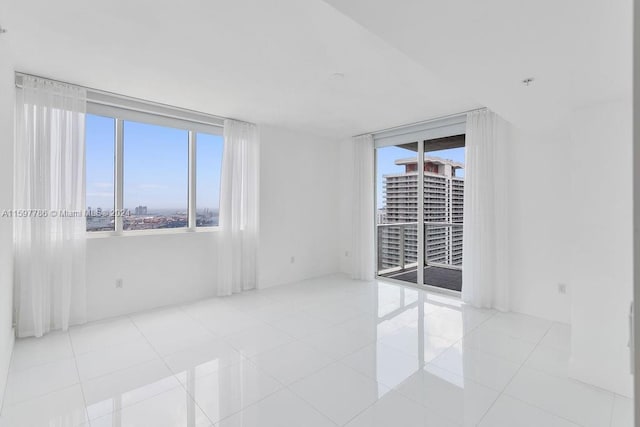 tiled empty room featuring a view of city