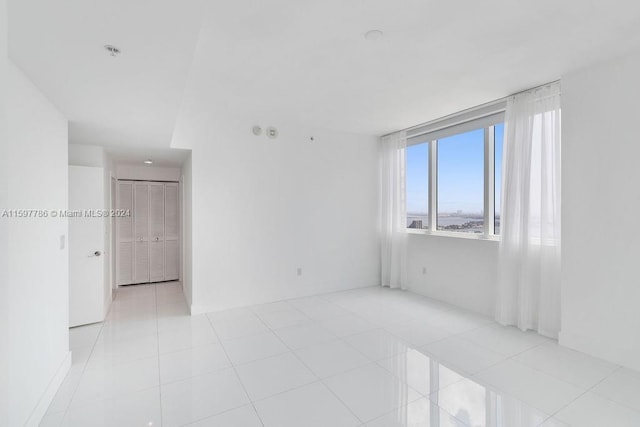 empty room with light tile patterned flooring