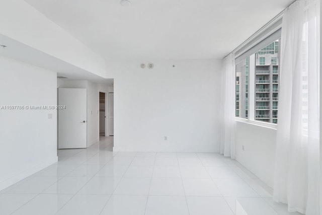 unfurnished room with light tile patterned floors