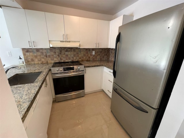 kitchen featuring white cabinetry, sink, dark stone counters, and appliances with stainless steel finishes