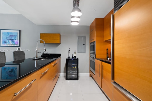 kitchen featuring sink, light tile flooring, pendant lighting, and built in appliances