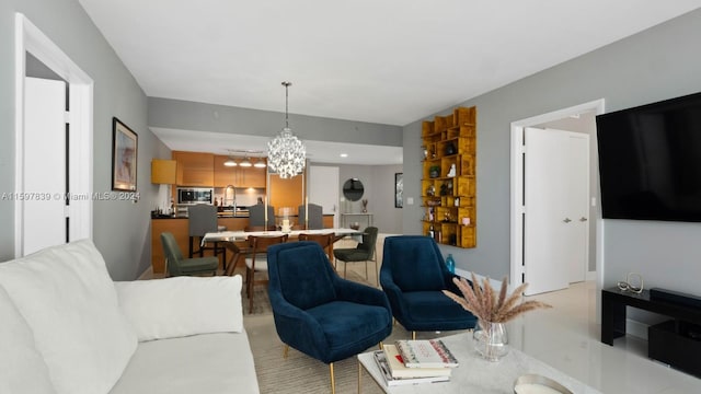 living room with a notable chandelier and sink