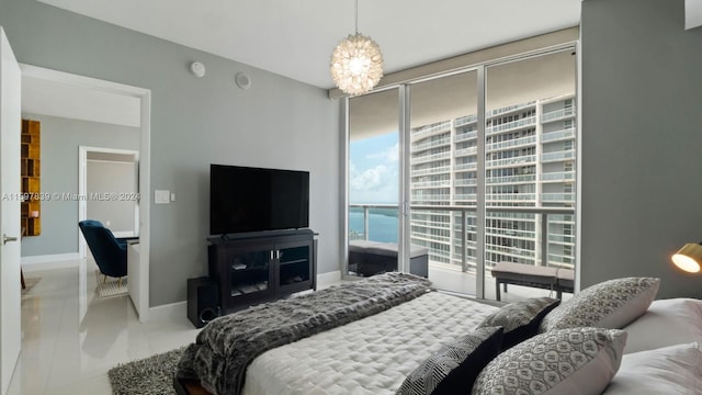 bedroom featuring a notable chandelier, a water view, light tile floors, and access to outside