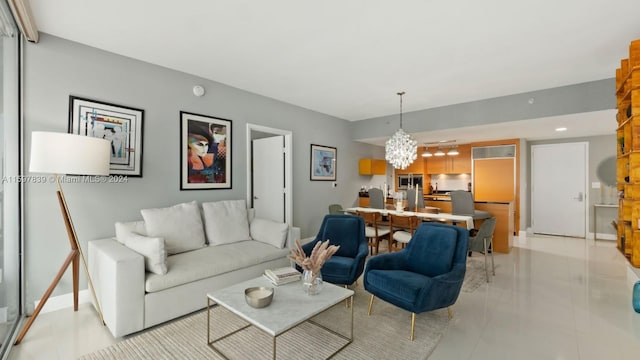 living room with a notable chandelier and light tile floors