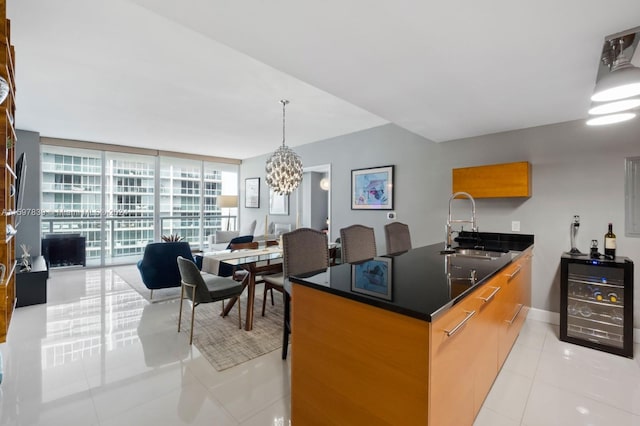 kitchen featuring beverage cooler, expansive windows, decorative light fixtures, light tile flooring, and a chandelier