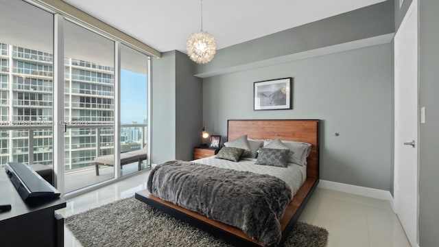 tiled bedroom featuring an inviting chandelier, expansive windows, and access to outside