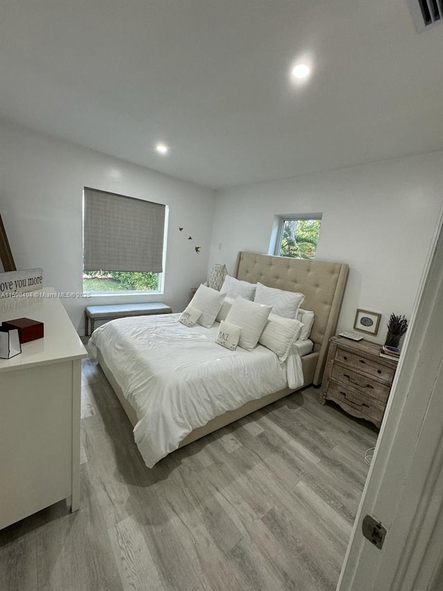 bedroom featuring visible vents, wood finished floors, and recessed lighting