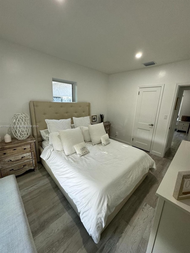 bedroom with wood finished floors and visible vents