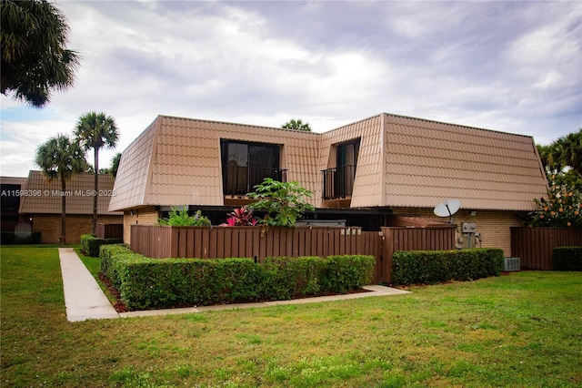 exterior space featuring a yard and central AC unit