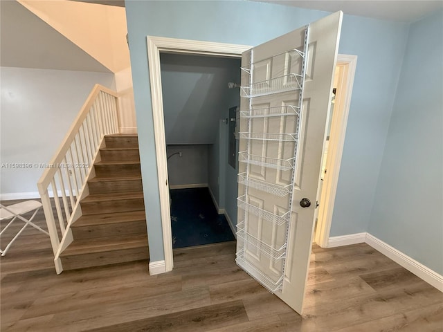 stairs featuring hardwood / wood-style floors