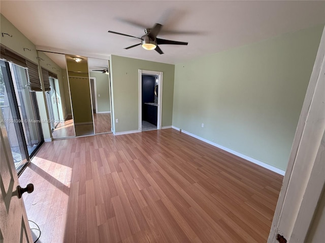 empty room with ceiling fan and light wood-type flooring