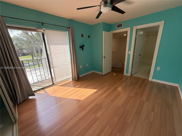 unfurnished bedroom with access to exterior, ensuite bath, ceiling fan, and light wood-type flooring