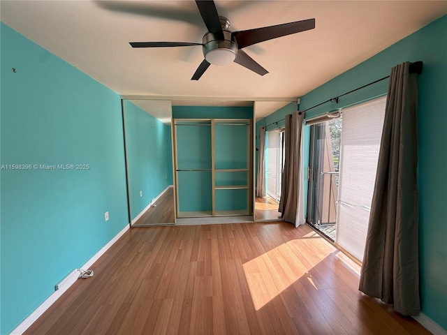 unfurnished room featuring ceiling fan and wood-type flooring