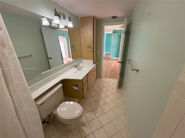 bathroom with vanity, toilet, and tile patterned flooring