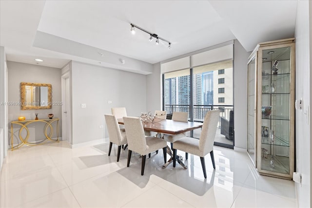 dining room featuring light tile patterned flooring and expansive windows