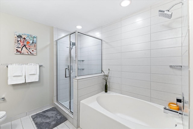 bathroom featuring tile patterned floors, toilet, and independent shower and bath