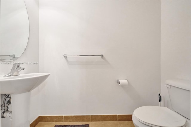 bathroom with tile patterned flooring and toilet