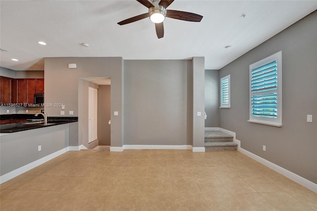 interior space featuring ceiling fan and sink