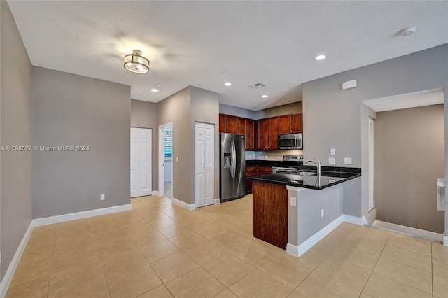 kitchen with kitchen peninsula, light tile patterned floors, stainless steel appliances, and sink