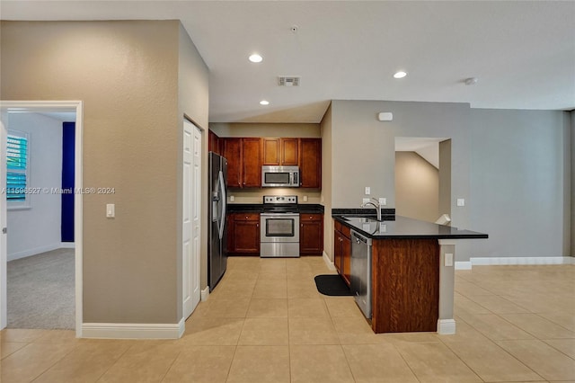 kitchen featuring sink, light tile patterned flooring, and appliances with stainless steel finishes