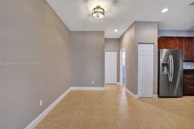 kitchen with light tile patterned flooring and stainless steel fridge with ice dispenser