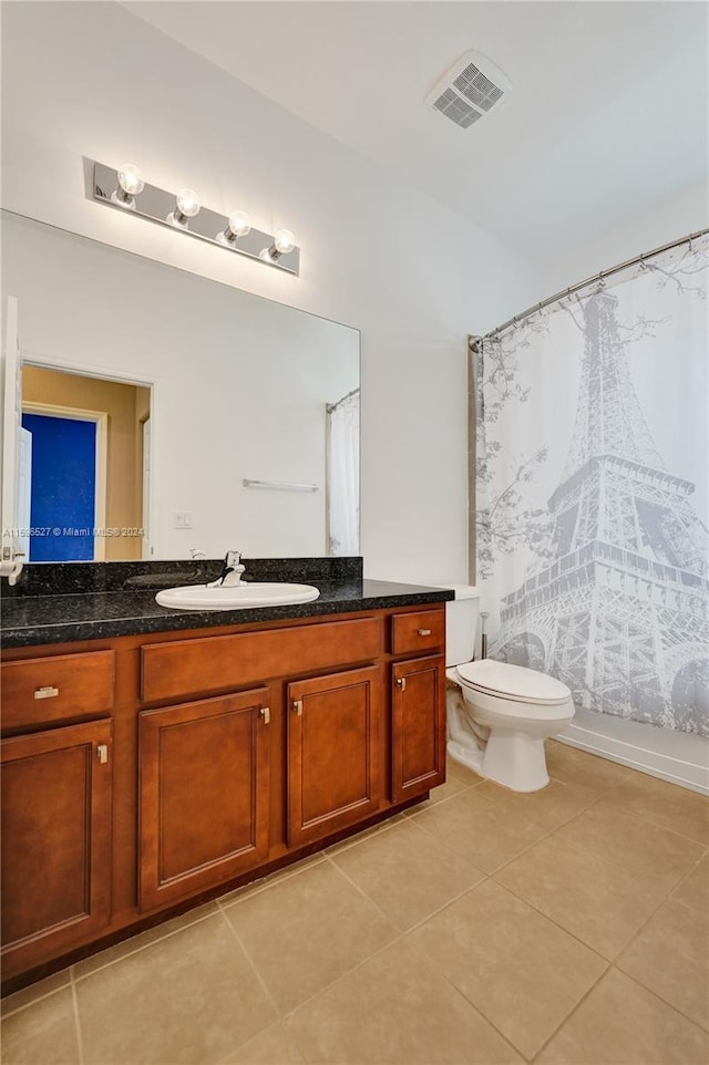 full bathroom featuring tile patterned flooring, vanity, shower / tub combo with curtain, and toilet