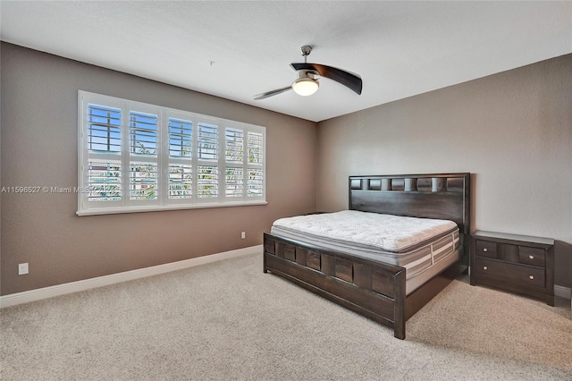 bedroom with light carpet and ceiling fan