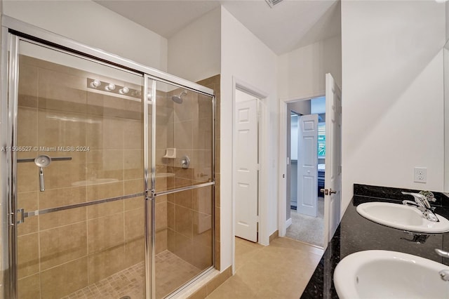 bathroom featuring tile patterned flooring, vanity, and an enclosed shower