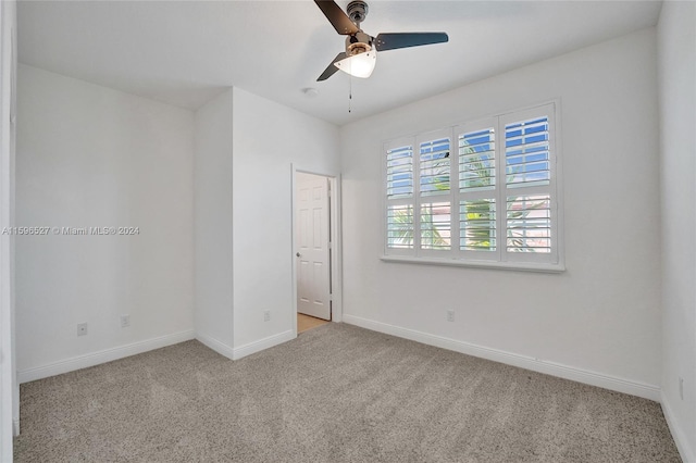 empty room featuring light carpet and ceiling fan